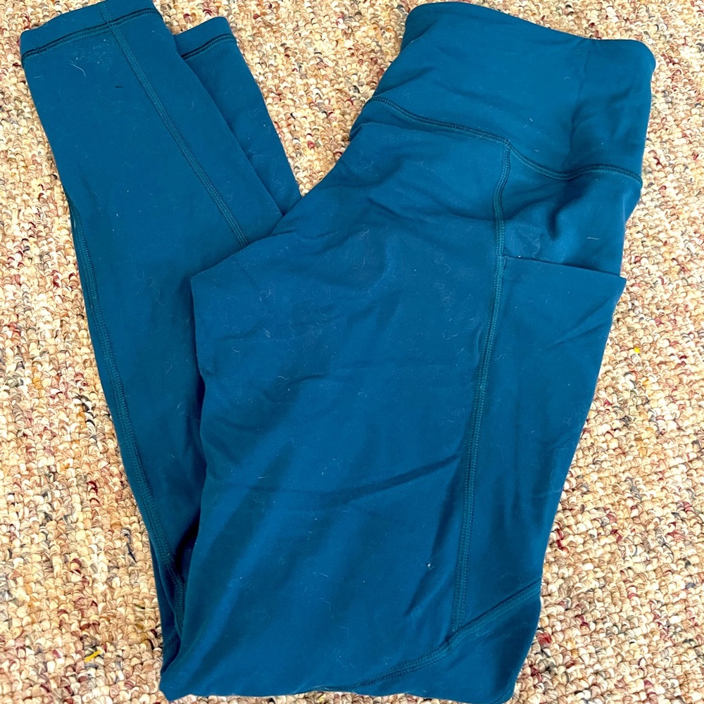 Athleta teal leggings with pockets medium salutation stash